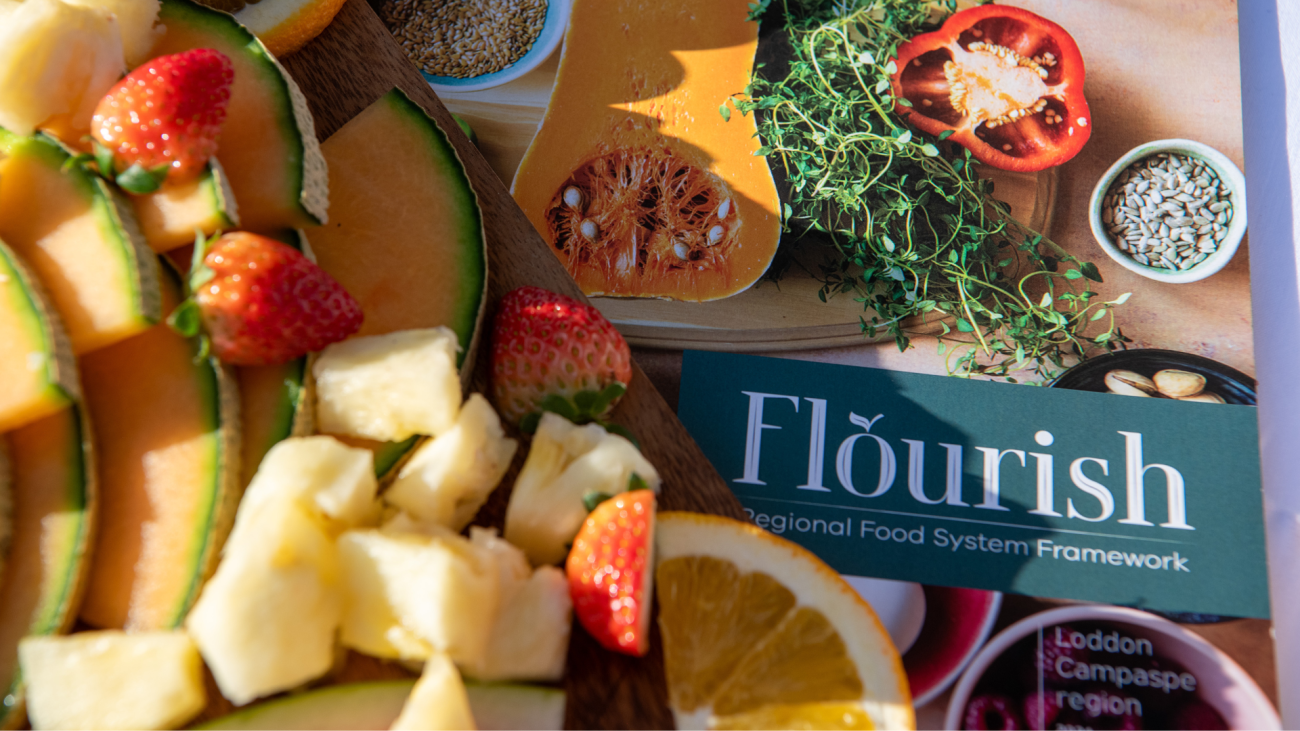 Cut up fruit sitting next to a copy of the Flourish Framework